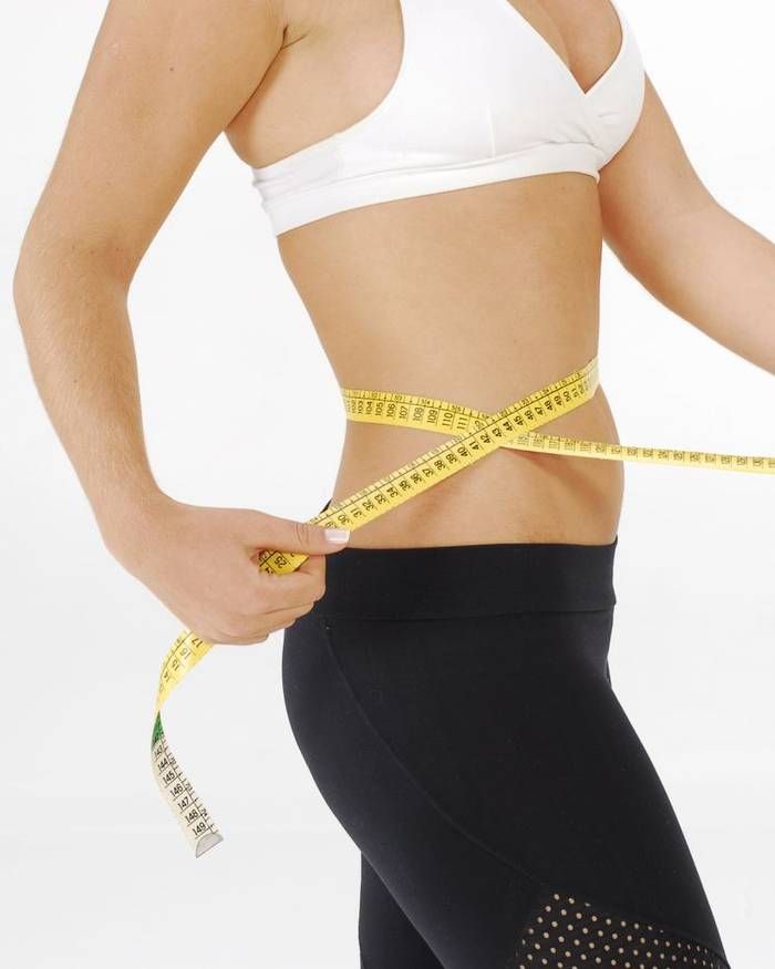 Woman measuring her waist